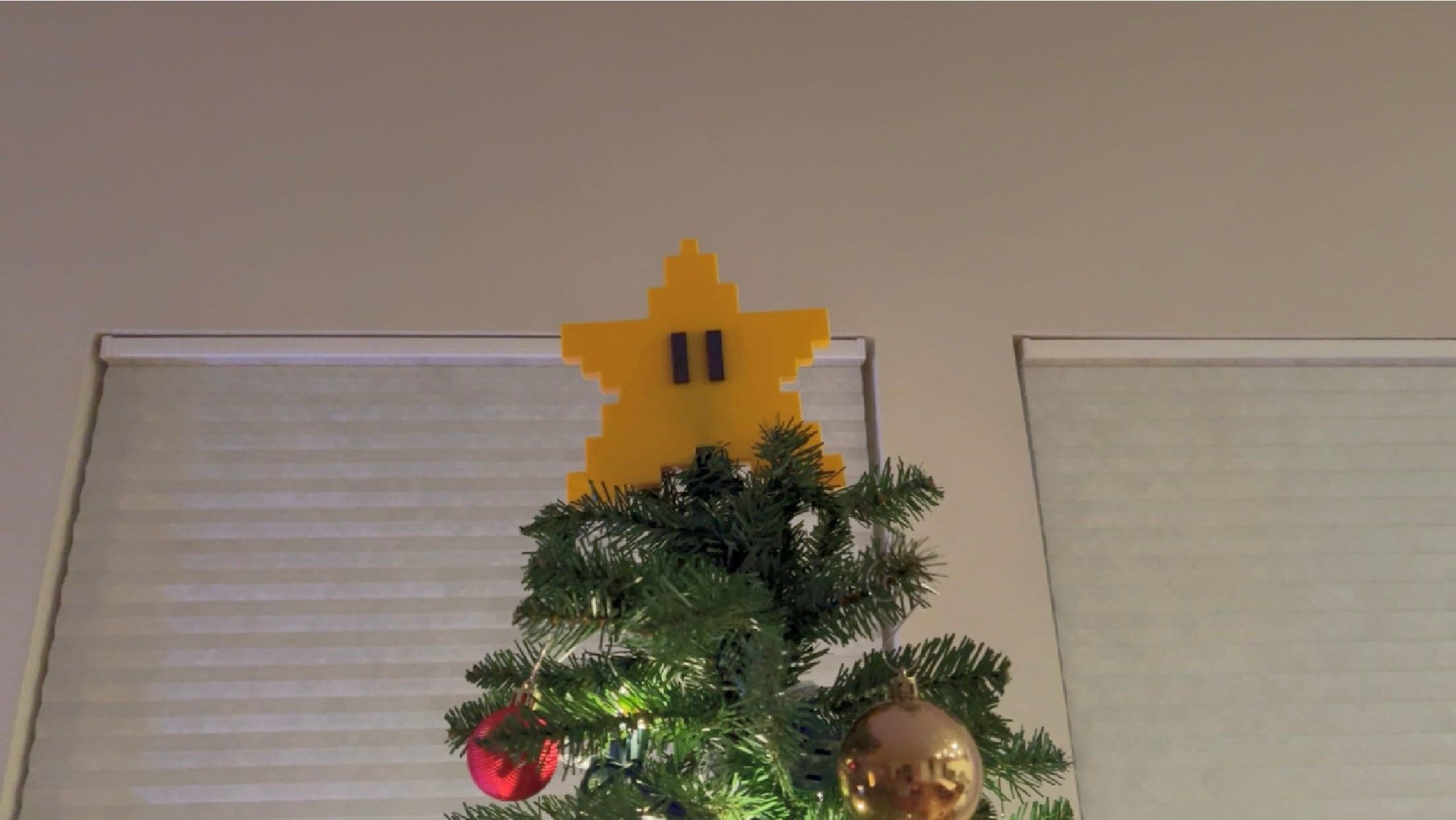 close up photo of the mario start on top of the tree