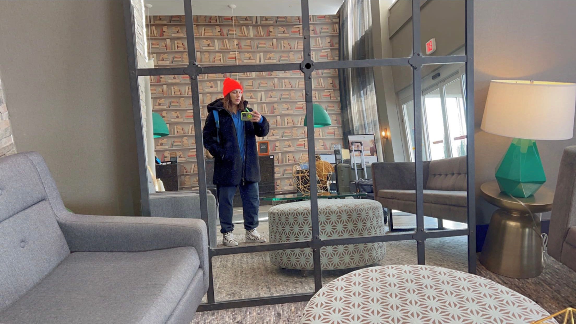 andrea valdez taking a mirror selfie in the hotel lobby