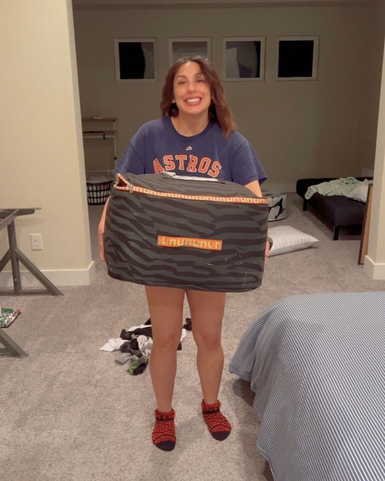 andrea valdez holding a box of coats from her nuuly rental order
